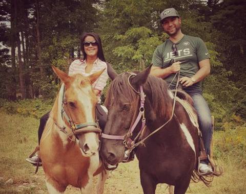 couple posing on horses during private ride at Mountain Creek Riding Stable