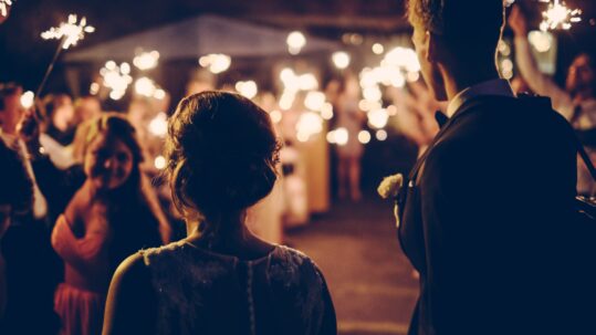 Silhouette of Couple at Wedding with Sparklers in Background