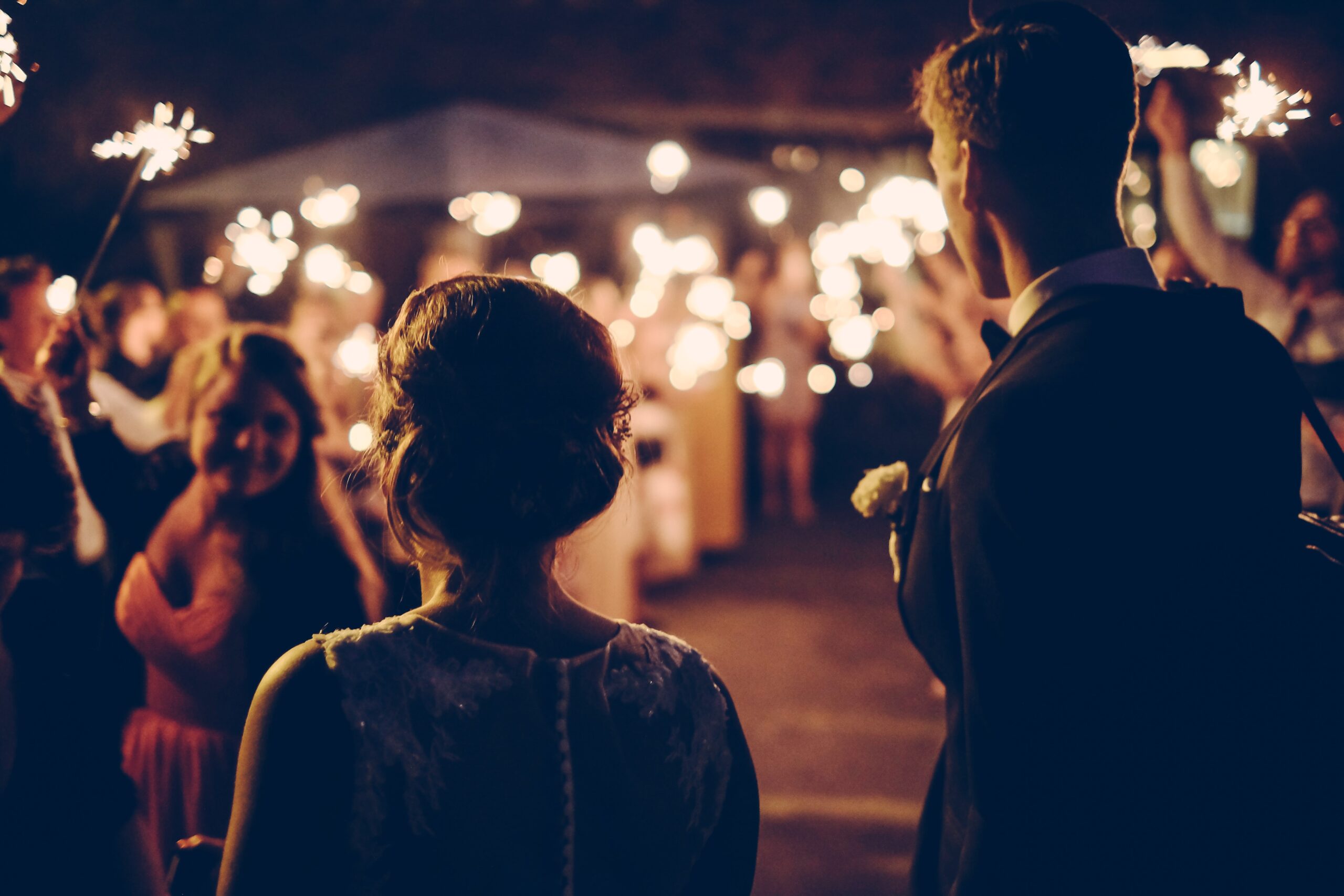 Silhouette of Couple at Wedding with Sparklers in Background