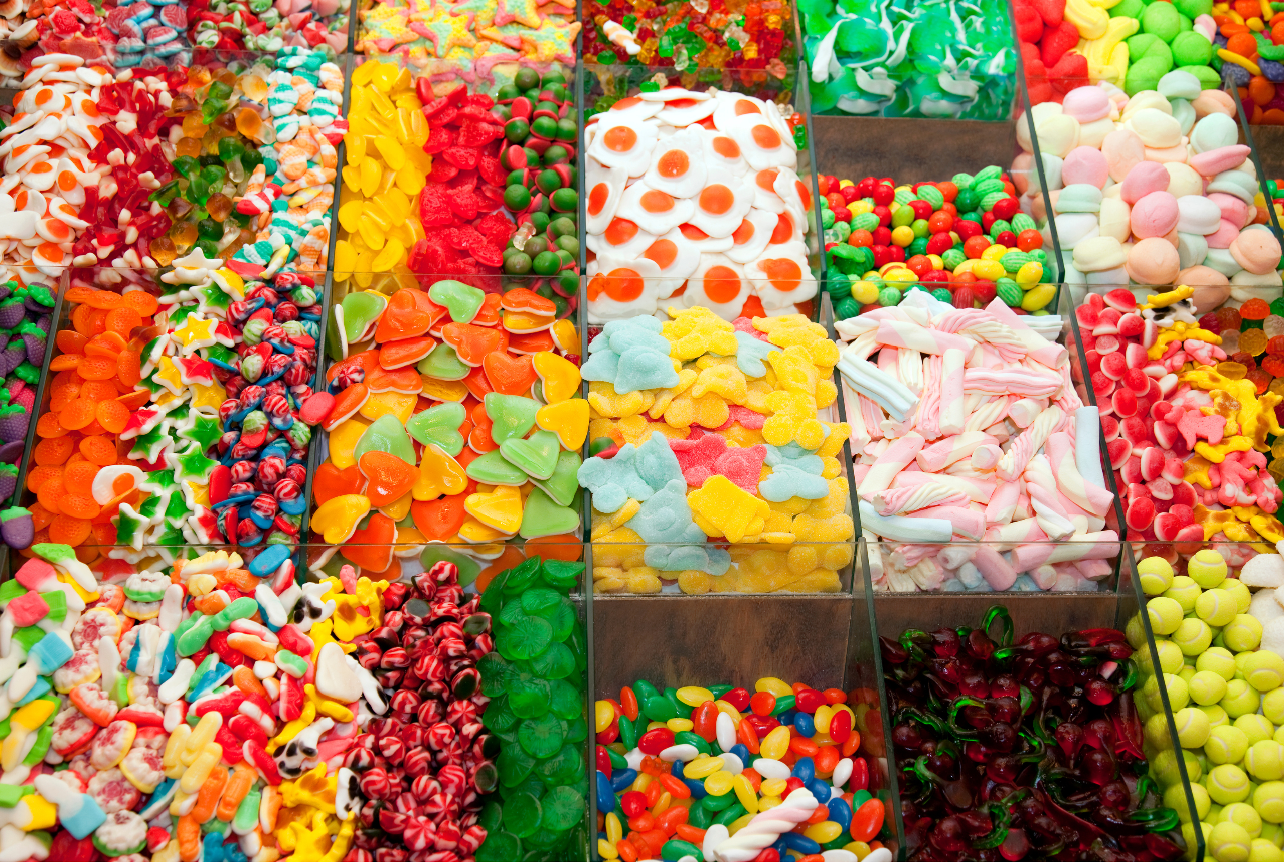 Bins of different colored candy, separated by candy type