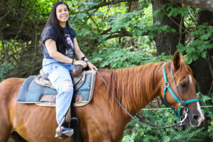 Girl Riding Brown Horse in Pocono Mountain Forest